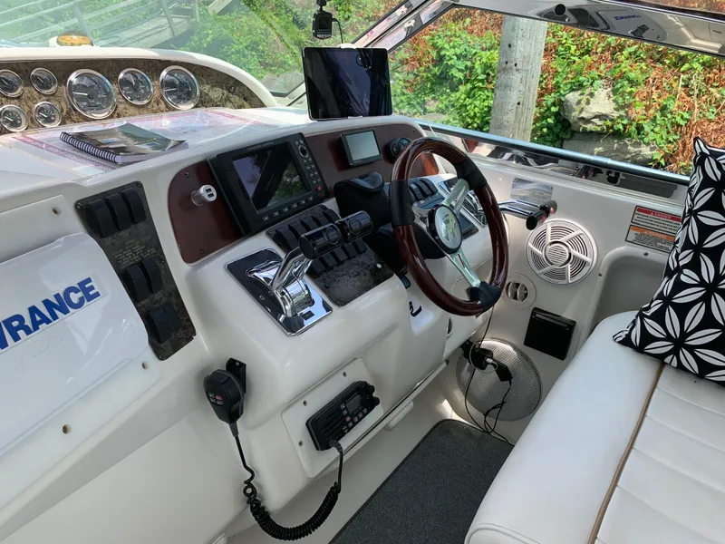 Slide: The Image of 1997 Sea Ray 370 Sundancer helm with modern navigation equipment and comfortable seating. - 33