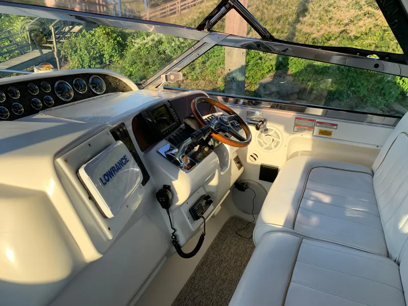 Slide: The Image of 1997 Sea Ray 370 Sundancer helm with Lowrance navigation system and leather seating. - 34