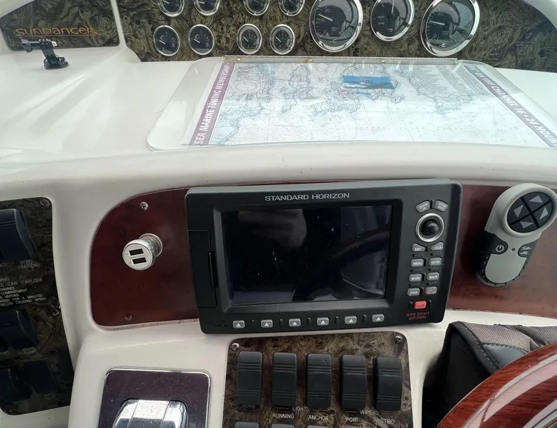 Slide: The Image of 1997 Sea Ray 370 Sundancer dashboard with navigation equipment and map. - 37