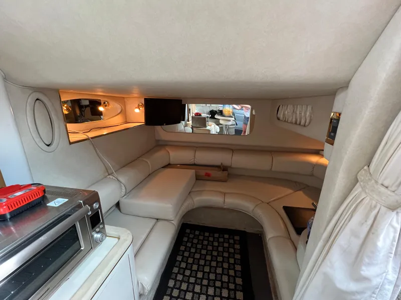 Slide: The Image of Interior of 1997 Sea Ray 370 Sundancer with beige seating and modern amenities. - 39