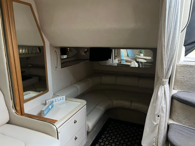 Slide: The Image of Interior of 1997 Sea Ray 370 Sundancer with cozy seating and mirror. - 40