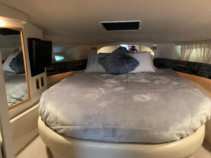 Slide: The Image of Luxurious bedroom in 1997 Sea Ray 370 Sundancer yacht with plush bedding. - 42