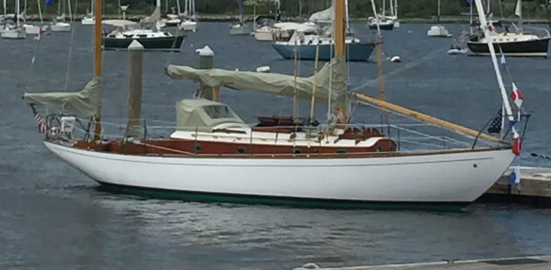 The Image of Classic 1955 Concordia Yawl sailboat docked in a marina, showcasing elegant design and craftsmanship. - 0