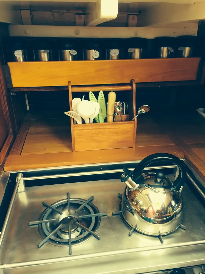 Slide: The Image of Vintage 1955 Concordia Yawl kitchen with stove, kettle, and utensil holder. - 13