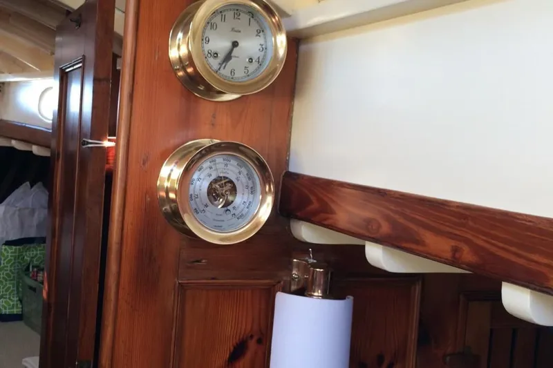 Slide: The Image of Interior of 1955 Concordia Yawl with brass instruments on wooden panel. - 14