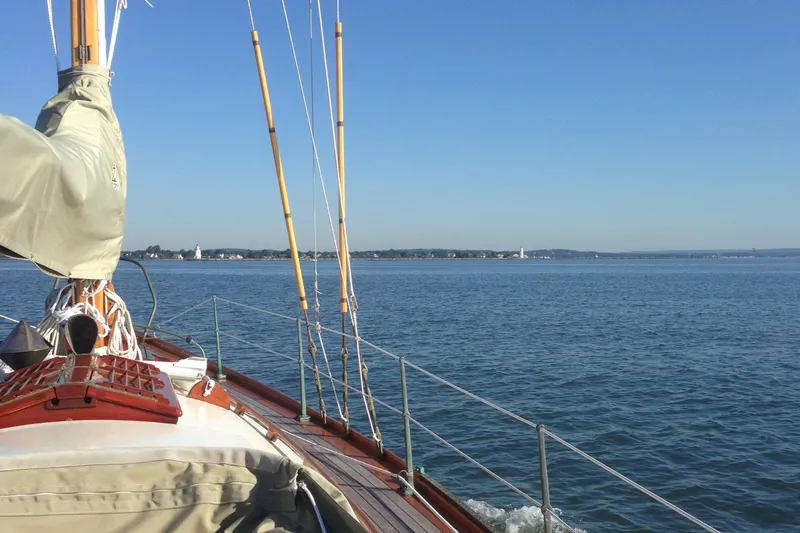 Slide: The Image of 1955 Concordia Yawl sailing on calm waters under clear blue sky. - 18