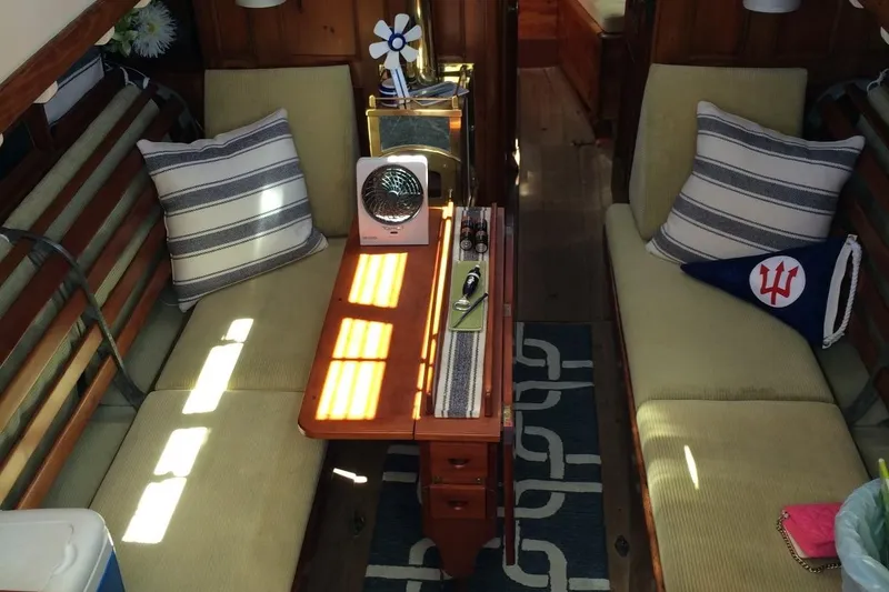 Slide: The Image of Interior of 1955 Concordia Yawl (Hull #33) with cozy seating and nautical decor. - 2