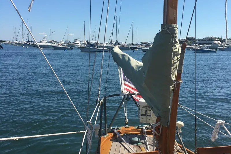 Slide: The Image of 1955 Concordia Yawl sailboat on calm water, surrounded by other boats. - 21