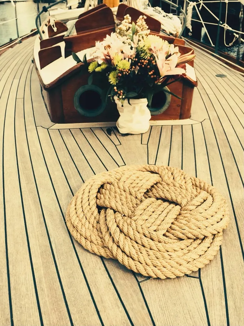 Slide: The Image of Vintage 1955 Concordia Yawl with decorative rope and floral arrangement on deck. - 22