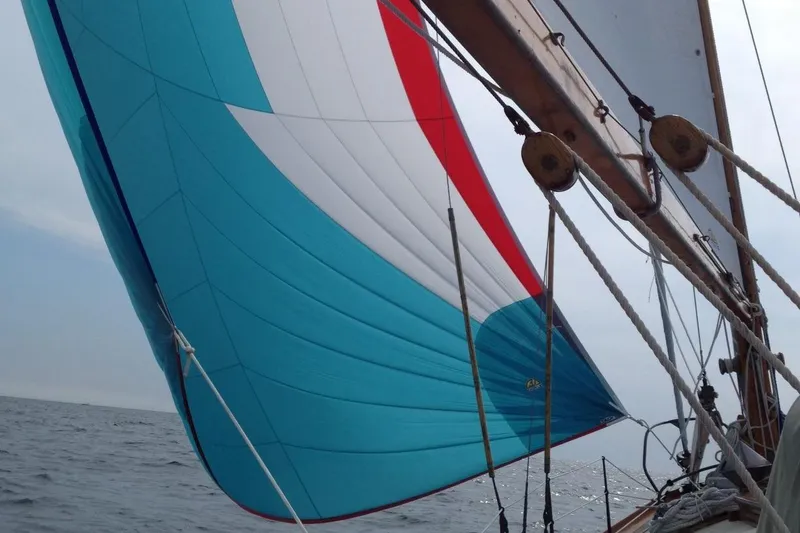 Slide: The Image of Sailing on a 1955 Concordia Yawl, vibrant spinnaker catching the wind. - 24