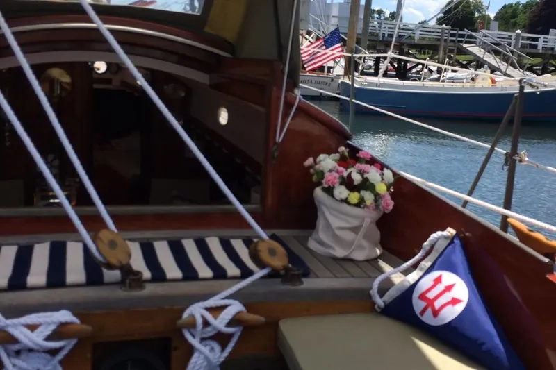 Slide: The Image of 1955 Concordia Yawl sailboat interior with striped cushions and floral arrangement. - 26