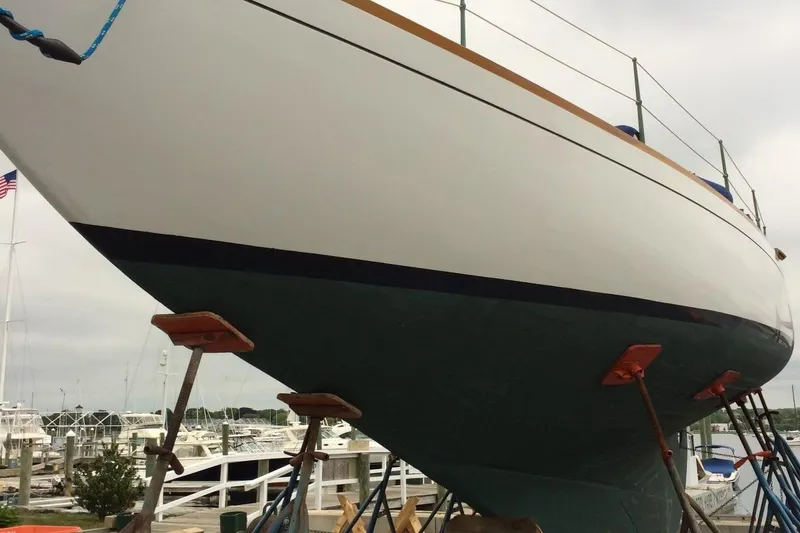 Slide: The Image of 1955 Concordia Yawl (Hull #33) on stands at a marina, showcasing its classic design. - 34