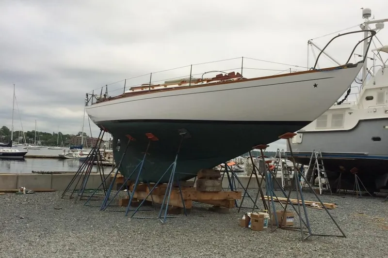 Slide: The Image of 1955 Concordia Yawl (Hull #33) on stands in a boatyard, ready for maintenance. - 35