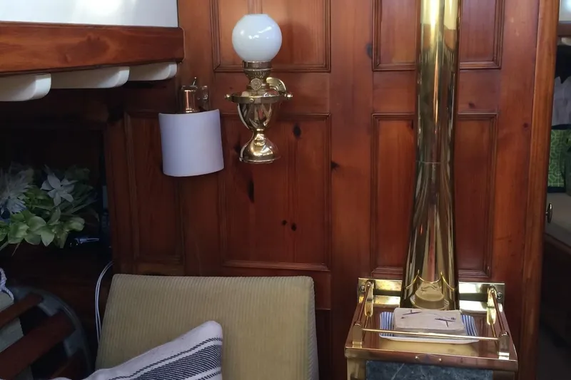 Slide: The Image of Interior of 1955 Concordia Yawl, featuring wood paneling and brass fixtures. - 4