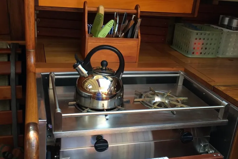 Slide: The Image of Stainless steel kettle on stove inside 1955 Concordia Yawl (Hull #33) sailboat kitchen. - 9
