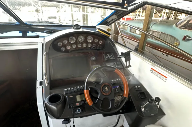 Slide: The Image of 2005 Sunseeker 350 boat cockpit with steering wheel and control panel. - 11