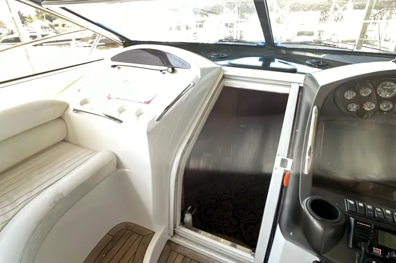 Slide: The Image of Interior cockpit of 2005 Sunseeker 350 yacht with control panel and seating. - 12