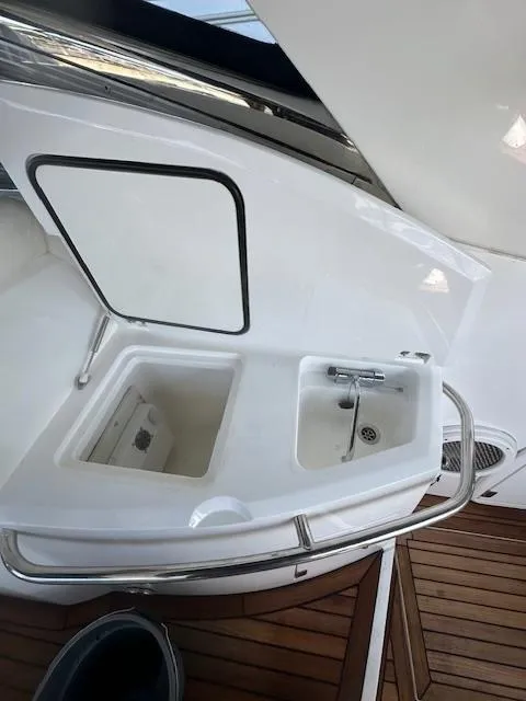 Slide: The Image of 2005 Sunseeker 350 yacht sink and storage area with teak flooring. - 26