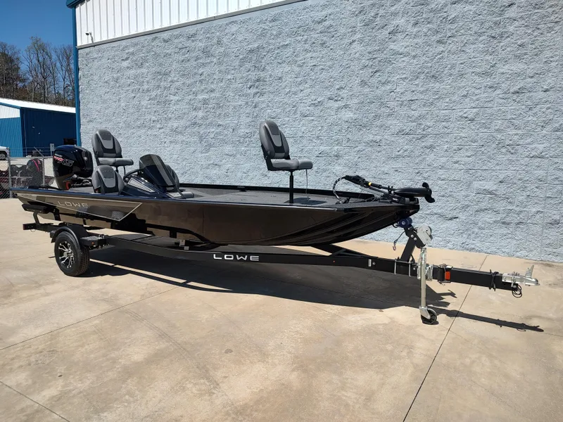 Slide: The Image of 2024 Lowe Stinger 195B fishing boat on trailer, parked outdoors. - 10