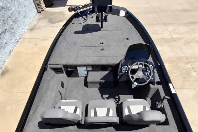 Slide: The Image of 2024 Lowe Stinger 195B fishing boat interior with three seats and steering console. - 4