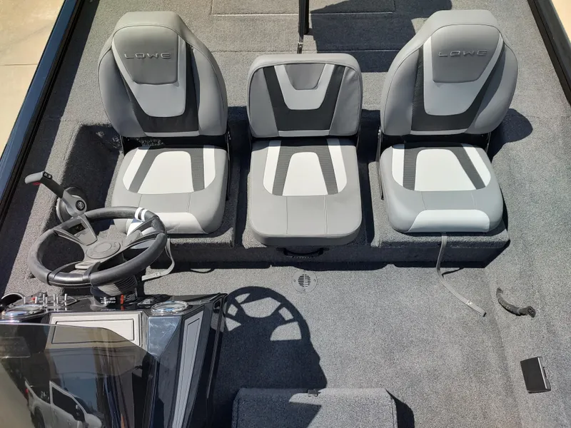 Slide: The Image of 2024 Lowe Stinger 195B boat interior with three gray and white seats. - 7