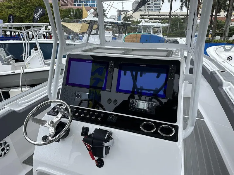 Slide: The Image of Custom 335 boat dashboard with dual screens and steering wheel, 2024 model. - 1