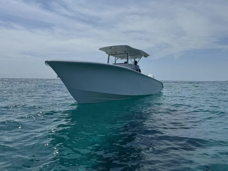 Slide: The Image of Custom 335 boat 2024 model on clear blue ocean water. - 12