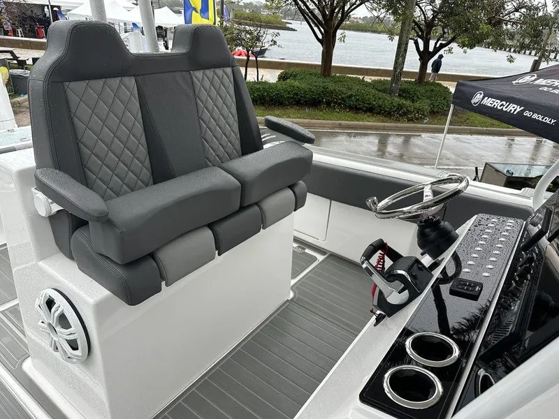 Slide: The Image of 2024 Custom 335 boat interior with dual seats and steering console. - 2
