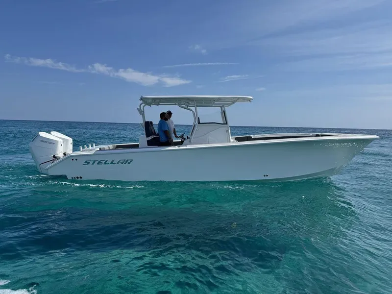 Slide: The Image of 2024 Custom 335 boat on clear blue ocean water. - 7