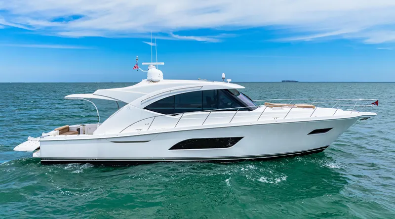 Slide: The Image of 2017 Riviera 575 SUV luxury yacht cruising on open water. - 1