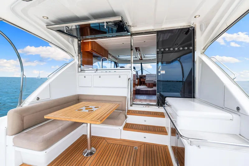 Slide: The Image of 2017 Riviera 575 SUV yacht interior with seating area and ocean view. - 16