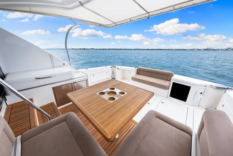 Slide: The Image of 2017 Riviera 575 SUV yacht deck with seating and ocean view. - 18