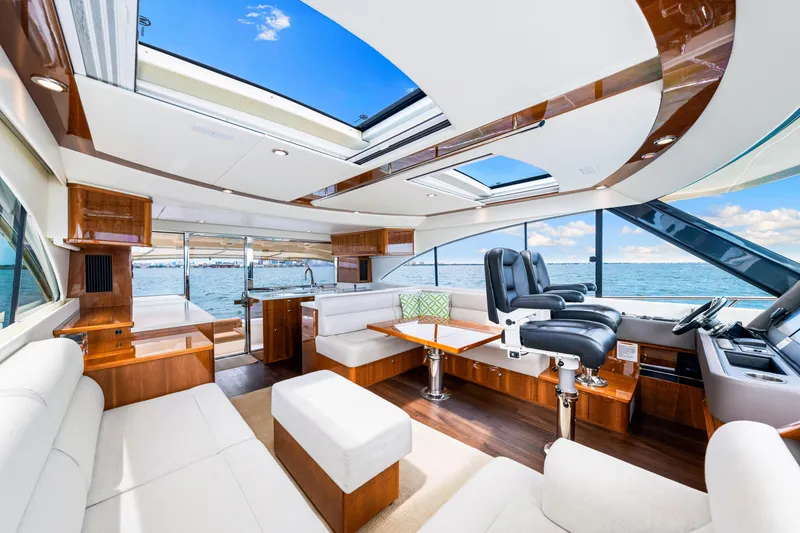 Slide: The Image of Luxurious interior of 2017 Riviera 575 SUV yacht with panoramic windows and plush seating. - 29