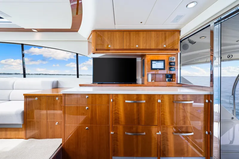 Slide: The Image of Interior of 2017 Riviera 575 SUV yacht with wooden cabinetry and ocean view. - 37