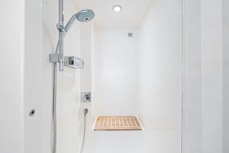Slide: The Image of 2017 Riviera 575 SUV yacht shower with modern fixtures and wooden floor mat. - 46