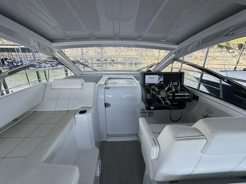 Slide: The Image of 2021 Cruisers Yachts 39 Express Coupe helm with modern controls and comfortable seating. - 14
