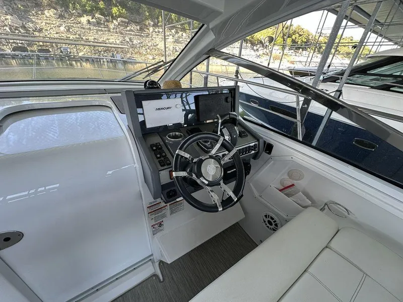 Slide: The Image of 2021 Cruisers Yachts 39 Express Coupe interior with white seating and lake view. - 15