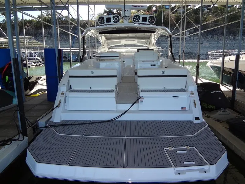 Slide: The Image of 2021 Cruisers Yachts 39 Express Coupe docked under a marina shelter. - 21