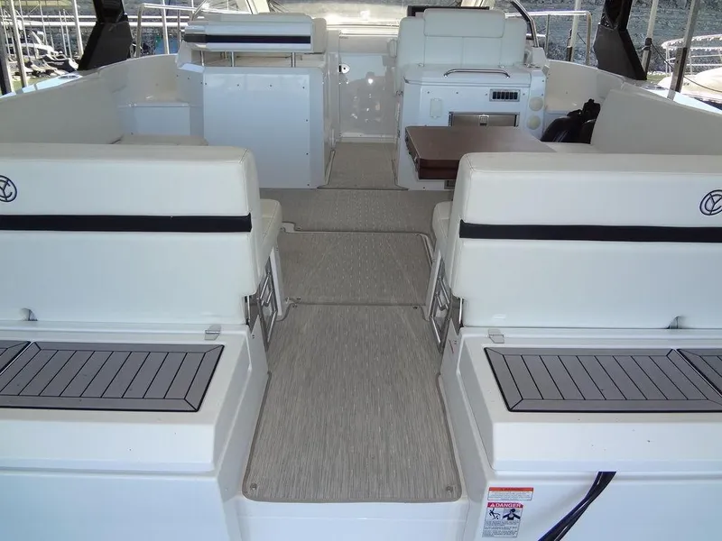 Slide: The Image of 2021 Cruisers Yachts 39 Express Coupe interior with sleek white seating and modern helm. - 28