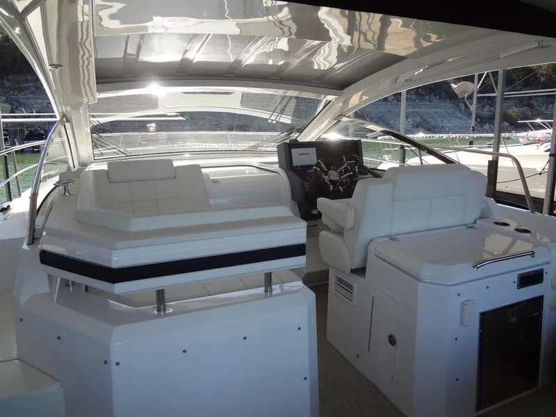 Slide: The Image of 2021 Cruisers Yachts 39 Express Coupe interior seating with wooden table. - 29