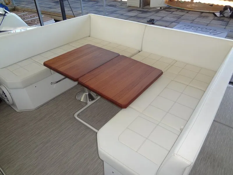 Slide: The Image of 2021 Cruisers Yachts 39 Express Coupe interior seating with wooden table. - 30