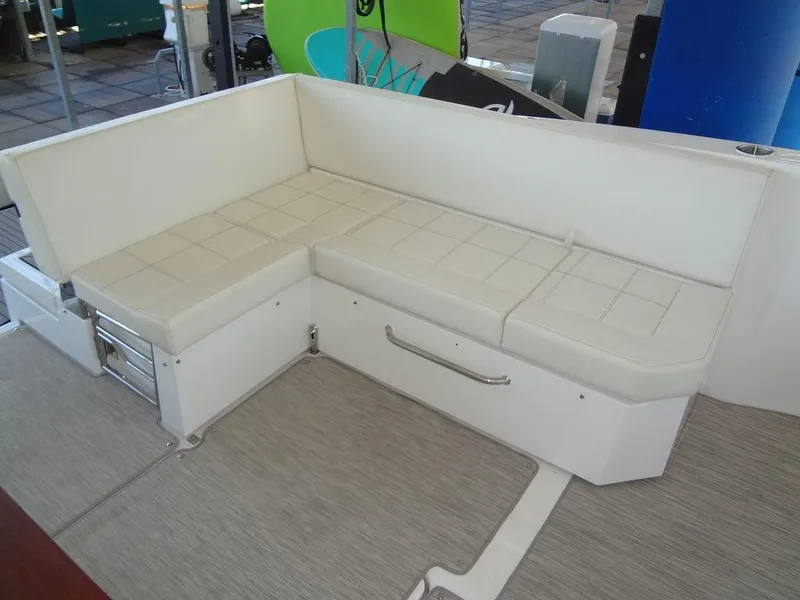 Slide: The Image of 2021 Cruisers Yachts 39 Express Coupe interior with white seating and wooden table. - 32