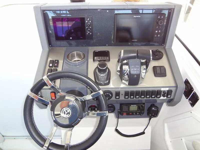 Slide: The Image of Control panel of 2021 Cruisers Yachts 39 Express Coupe with throttle and navigation controls. - 43