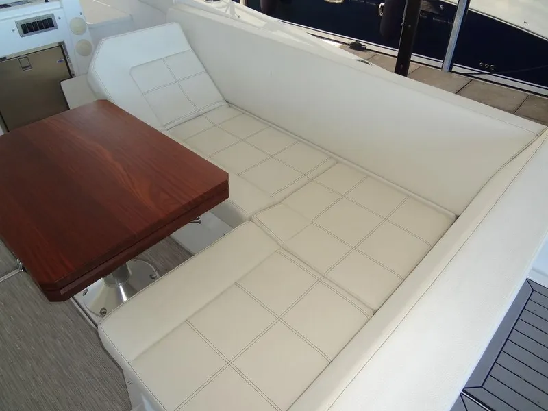 Slide: The Image of 2021 Cruisers Yachts 39 Express Coupe interior seating with white upholstery. - 46