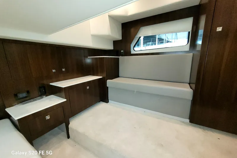 Slide: The Image of 2021 Cruisers Yachts 39 Express Coupe interior with wood paneling and seating area. - 65