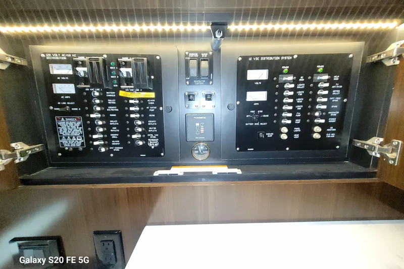 Slide: The Image of Electrical control panel of 2021 Cruisers Yachts 39 Express Coupe, featuring switches and meters. - 68