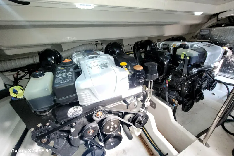 Slide: The Image of Engine room of 2021 Cruisers Yachts 39 Express Coupe, showcasing dual engines. - 70