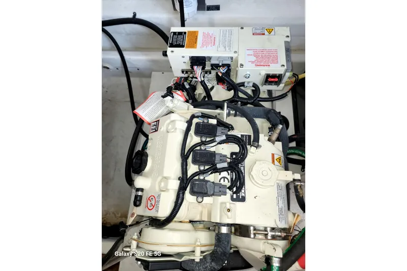 Slide: The Image of Engine compartment of 2021 Cruisers Yachts 39 Express Coupe, showcasing electrical components and wiring. - 73