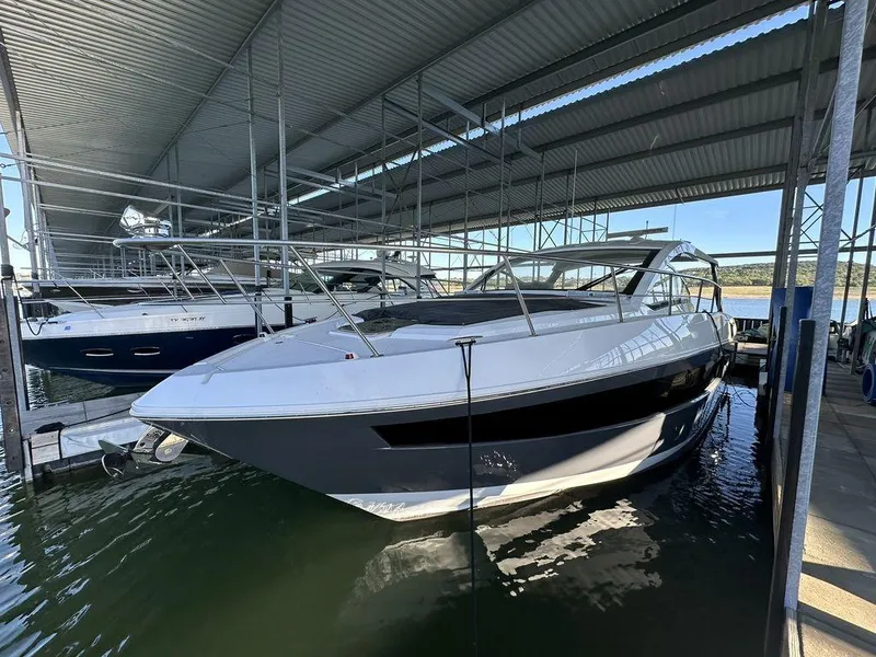 Slide: The Image of 2021 Cruisers Yachts 39 Express Coupe with spacious deck and seating in marina. - 8