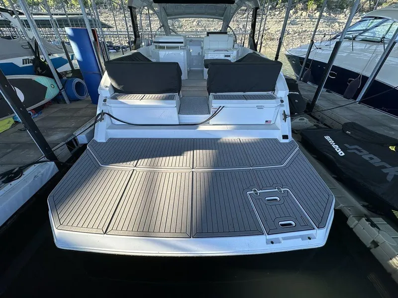 Slide: The Image of 2021 Cruisers Yachts 39 Express Coupe, spacious deck view, modern design, docked in marina. - 9